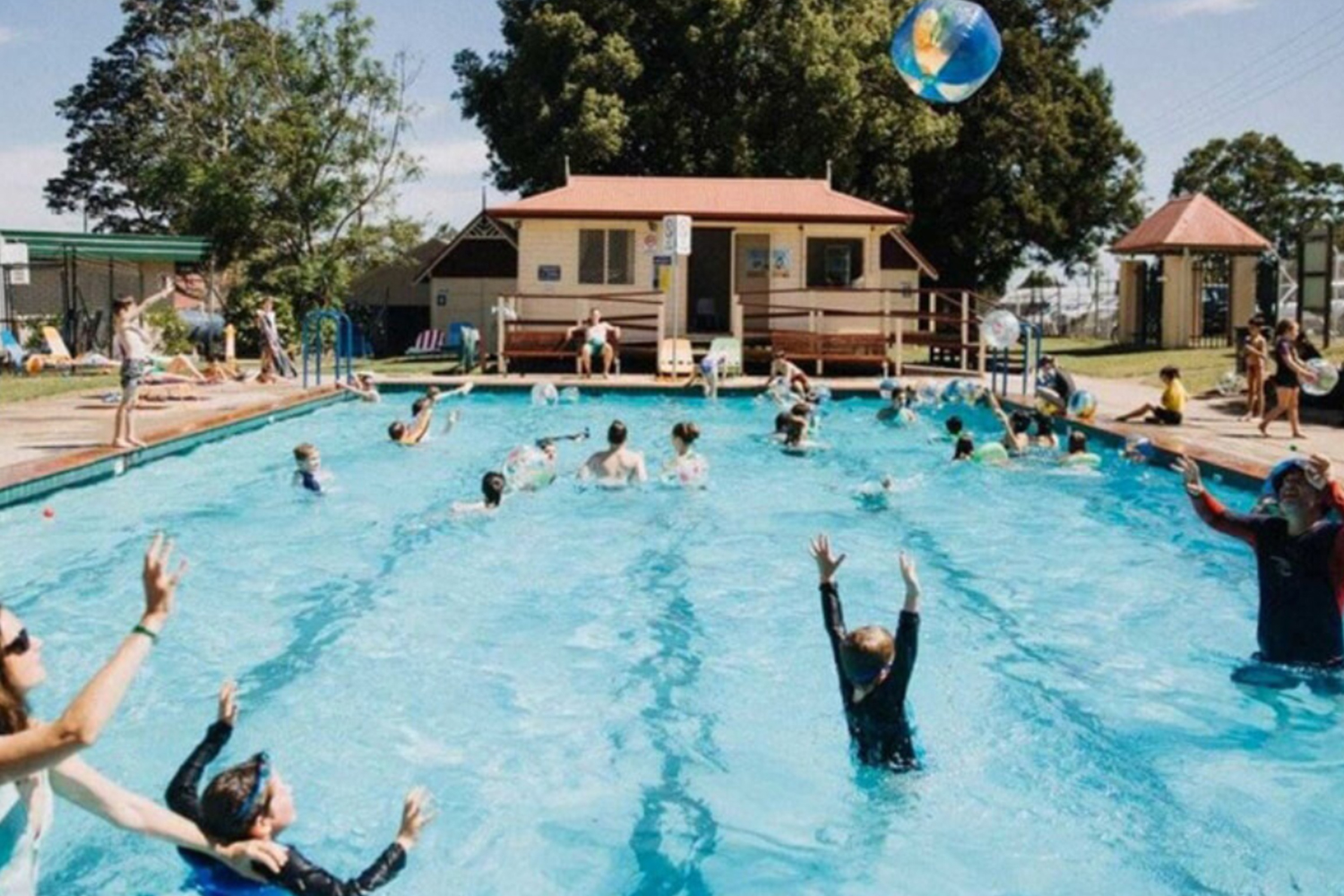 A photo of Berry Village Pool. There are a number of people playing in the pool.