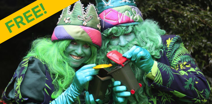 two actors in costumes holding minature waste and recycling bins.