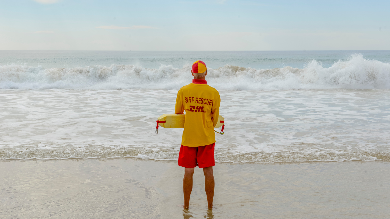 Surf life saving lifeguard patrolling beach