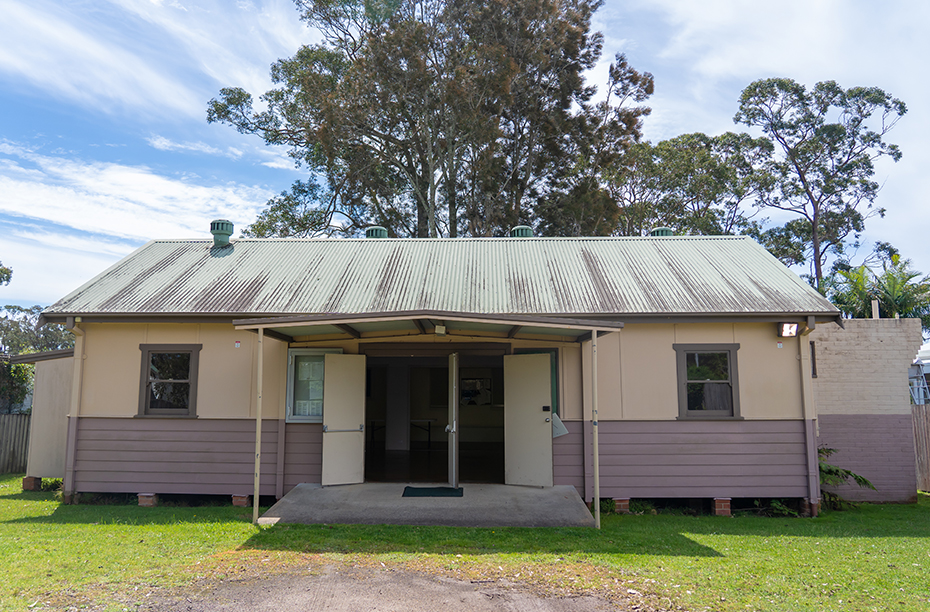 Street view of community hall with weatherboard panels and pitched roof