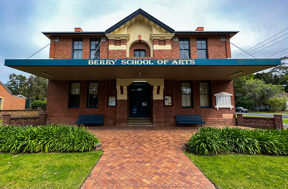 Street view of a large two storey brick hall with pitched roof